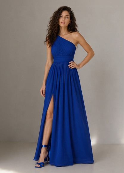 Woman wearing a blue one-shoulder dress with a slit on a neutral background